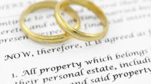 Form of prenuptial agreement with a pair of wedding rings. Shallow DOF on the word PROPERTY.