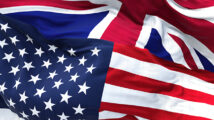 The flags of the United States and the United Kingdom waving in the wind. International business