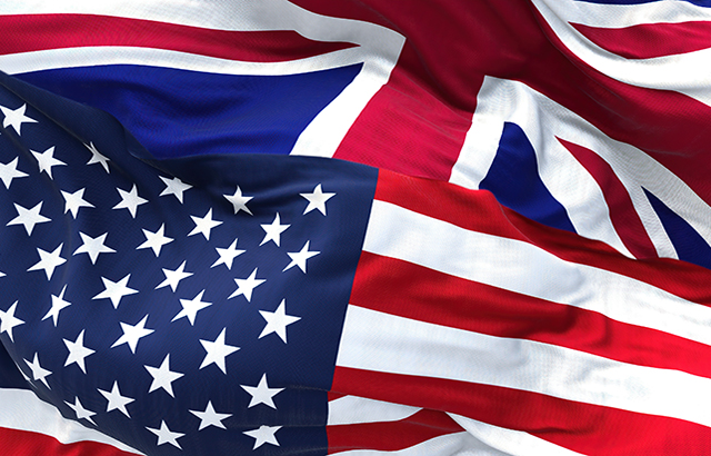 The flags of the United States and the United Kingdom waving in the wind. International business