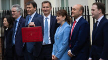 The Chancellor of the Exchequer Jeremy Hunt, accompanied by his ministerial team and watched by his wife and children, leaves 11 Downing Street on his way to deliver the budget.