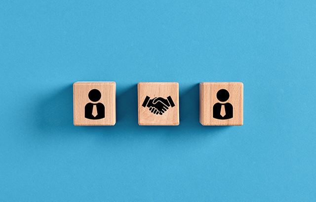 Business deal, agreement or contract concept. Employee manager and handshake icons on wooden cubes