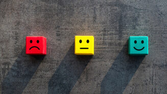 Customer satisfaction measurement unhappy okay and happy faces on coloured red yellow green wood blocks - Commercial business success client rating metrics scale - Excellence, KPI and feedback concept