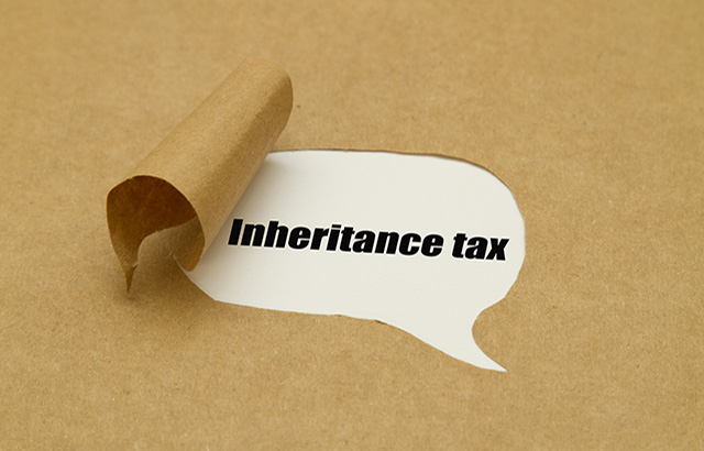 Inheritance tax written under torn paper.